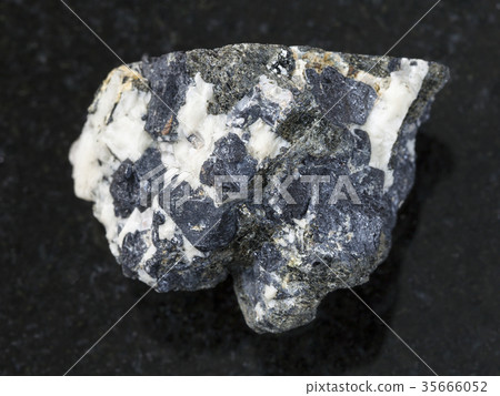 raw Knopite stone on dark background raw Knopite stone on dark background 35666052