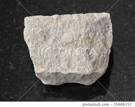 rough gray Dolomite stone on dark background rough gray Dolomite stone on dark background 35666151