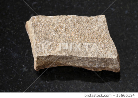 raw polymictic sandstone stone on dark 35666154