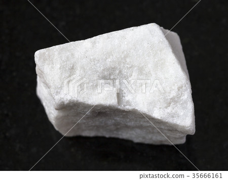 piece of raw white marble stone on dark piece of raw white marble stone on dark 35666161