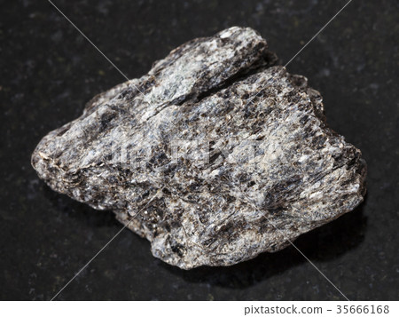 raw quartz-biotite schist stone on dark 35666168