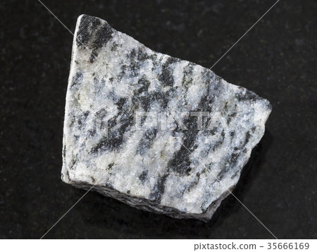 raw migmatite stone on dark background raw migmatite stone on dark background 35666169