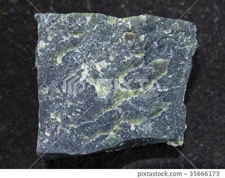 rough dunite stone on dark background rough dunite stone on dark background 35666173