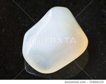 polished white Agate gemstone on dark background 35666229