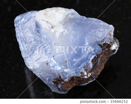 rough crystal of blue Chalcedony gemstone on dark 35666252