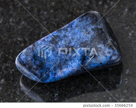 polished dumortierite gem on dark background 35666259