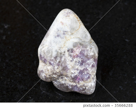 Lepidolite on polished quartz stone on dark 35666288