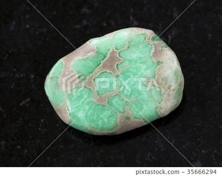 tumbled Variscite gemstone on dark background tumbled Variscite gemstone on dark background 35666294