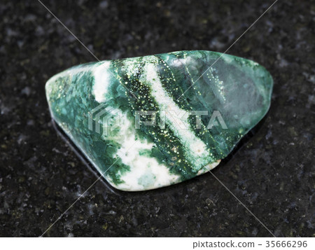 polished Chlorite gemstone on dark background polished Chlorite gemstone on dark background 35666296