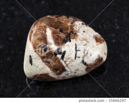 polished Spreustein with microcline stone on dark polished Spreustein with microcline stone on dark 35666297