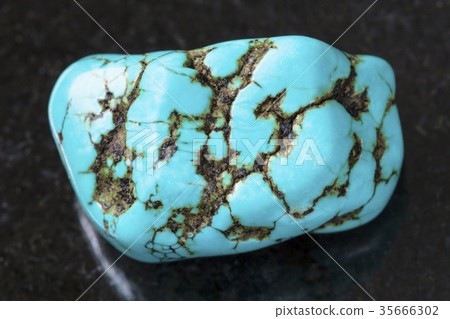 polished blue howlite (turquenite) gem on dark polished blue howlite (turquenite) gem on dark 35666302