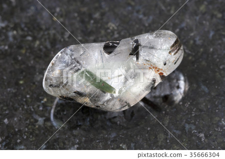 tumbled quartz gemstone with Tourmaline on dark tumbled quartz gemstone with Tourmaline on dark 35666304