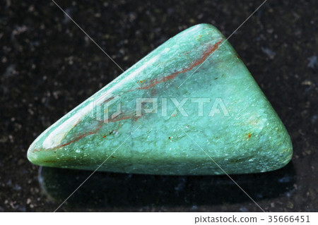 tumbled fuchsite (chrome mica) gemstone on dark 35666451