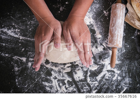 Male hands kneading dough sprinkled with flour table, Hands prep Male hands kneading dough sprinkled with flour table, Hands prep 35667616