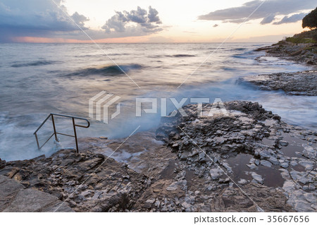 Stormy rocky beach sunset on Adriatic Sea Stormy rocky beach sunset on Adriatic Sea 35667656
