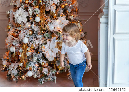 young girl near a Christmas tree 35669152