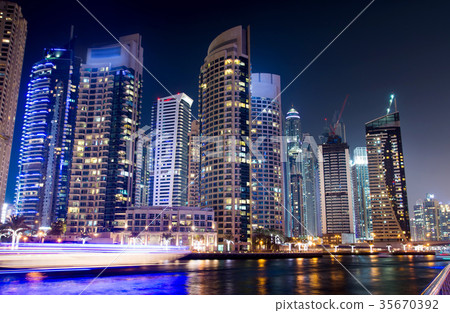 Dubai marina with skyscrapers and calm water night view 35670392