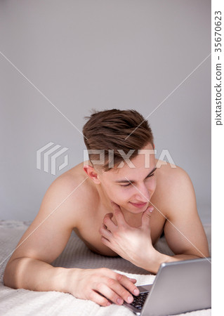 Muscled man online chatting with girl on bed 35670623