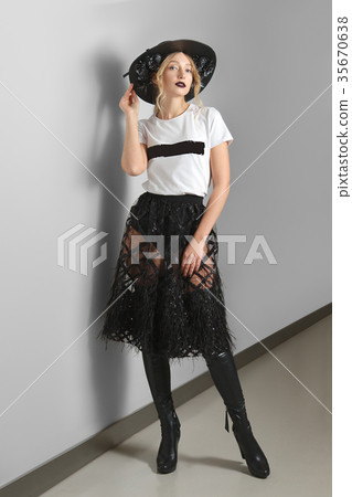 Pretty model in t-shirt, lace skirt and boots 35670638