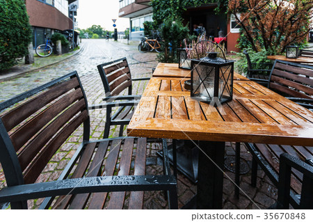 empty wooden wet table in outdoor cafe empty wooden wet table in outdoor cafe 35670848