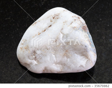 white marble pebble on dark background white marble pebble on dark background 35670862