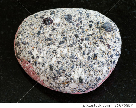 pebble of gray Arkose sandstone on dark background 35670897