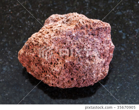 pebble of red pumice stone on dark background 35670905