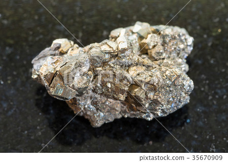 raw pyrite stone on dark background raw pyrite stone on dark background 35670909