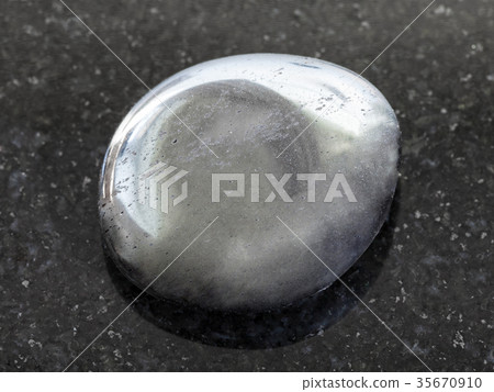tumbled hematite gemstone on dark background tumbled hematite gemstone on dark background 35670910