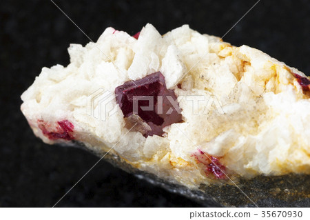 crystal of Cinnabar in rough Carbonatite on dark crystal of Cinnabar in rough Carbonatite on dark 35670930