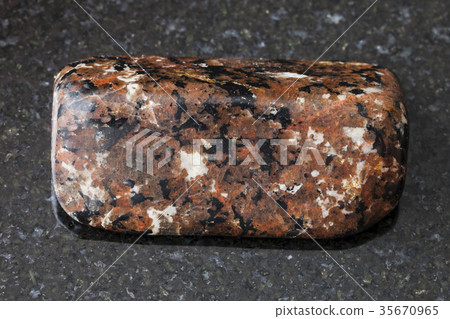 polished spreusteined urtite stone on dark polished spreusteined urtite stone on dark 35670965