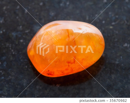 polished Carnelian gemstone on dark background polished Carnelian gemstone on dark background 35670982