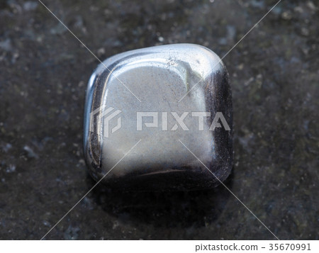 polished hematite stone on dark background 35670991