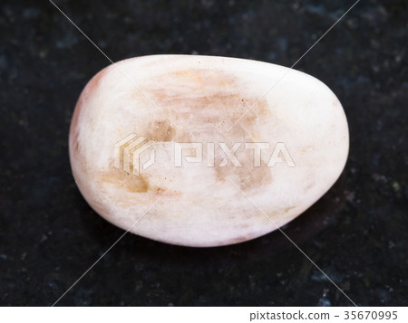 polished moonstone gemstone on dark background 35670995