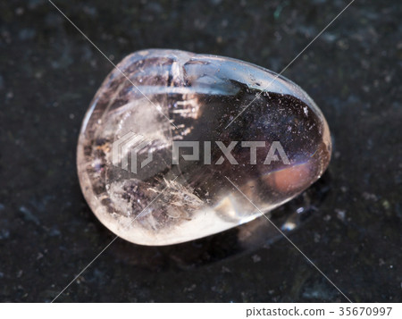 tumbled smoky quartz gemstone on dark 35670997