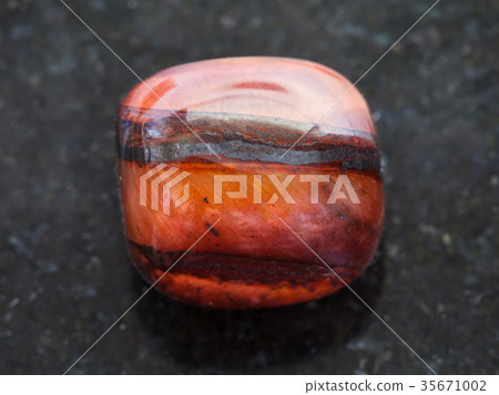 polished jaspilite gem stone on dark background polished jaspilite gem stone on dark background 35671002