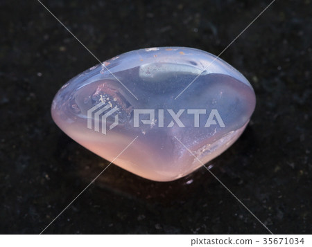 tumbled translucent moonstone gemstone on dark 35671034
