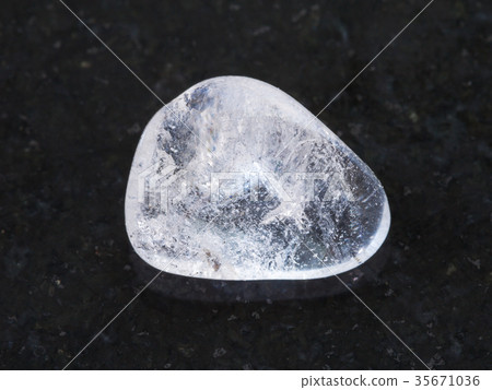 polished Rock-crystal gem stone on dark polished Rock-crystal gem stone on dark 35671036