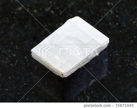 raw white calcite stone on dark background raw white calcite stone on dark background 35671045