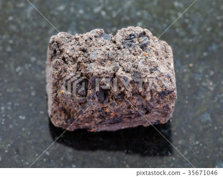 raw Peat Turf stone on dark background raw Peat Turf stone on dark background 35671046