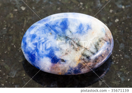 bead from Lazurite gemstone on dark background 35671139