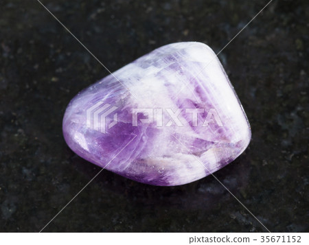 polished Amethyst gem stone on dark 35671152