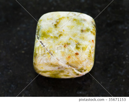 tumbled agate gem stone on dark background 35671153