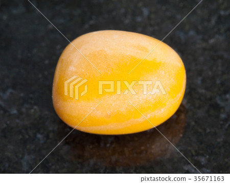 tumbled yellow jasper gemstone on dark 35671163