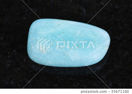 tumbled Aquamarine (blue beryl) gemstone on dark tumbled Aquamarine (blue beryl) gemstone on dark 35671180