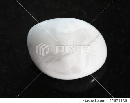 tumbled magnesite gemstone on dark background 35671186