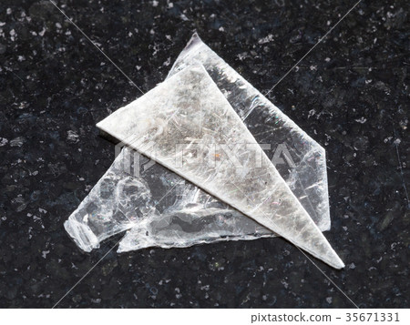 rough muscovite mica lamina on dark background 35671331