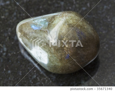 tumbled labradorite gem stone on dark background 35671340