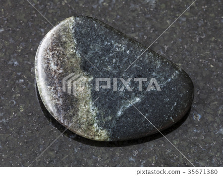 polished Olivenite stone on dark background 35671380