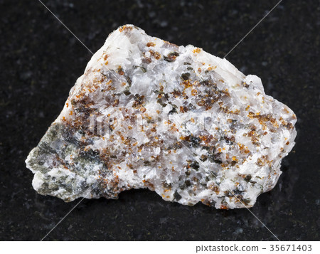 chondrodite and diopside in calcite stone on dark 35671403